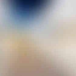 corridor between white cubicles with yellow wall and blue ceiling