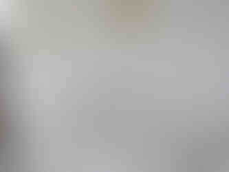 White tile with small grey accents on the floor of a shower