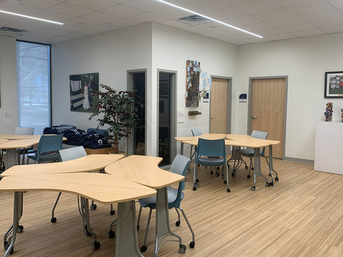 Desks and chairs arranged in a room for student collaboration workspace