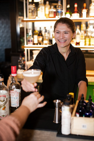 Greenville, SC food photography featuring a bartender serving a cocktail
