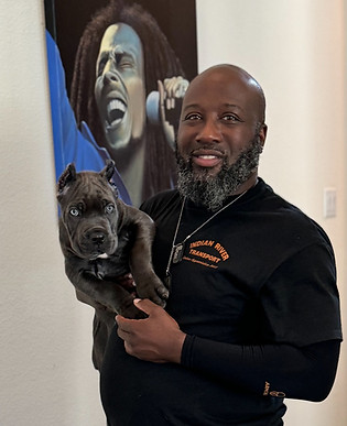 Man holding a gray puppy