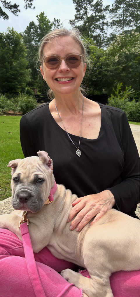 woman sitting with a small puppy