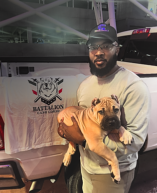 Man holding a tan puppy