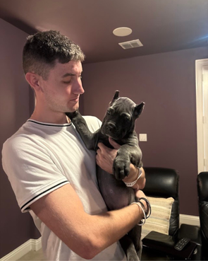 Man holding small puppy