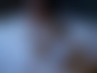 A women sitting anxiously on bed