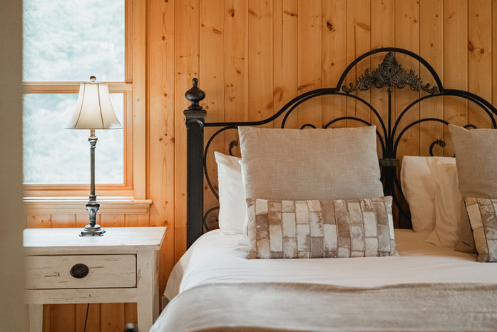 lovely rustic sidelamp and bed corner decorated with white sheets and pillow