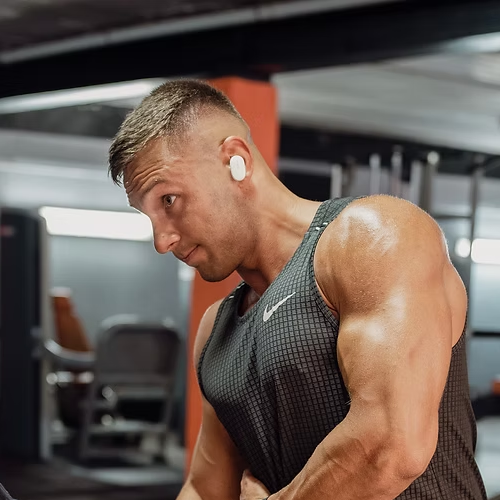 male personal trainer showing muscles