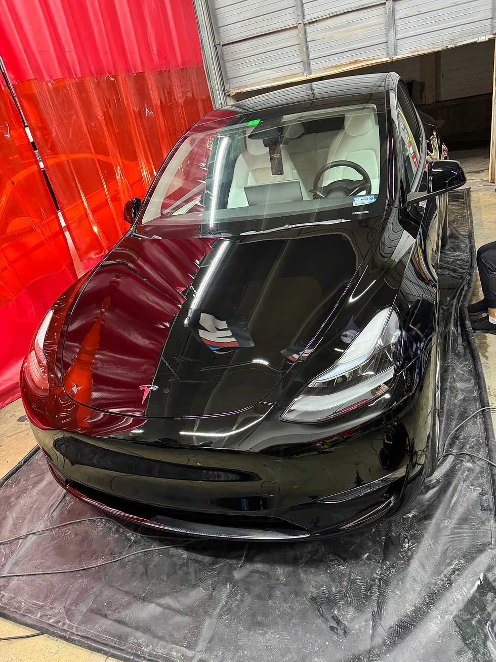 Tesla receiving paint correction and protection by ceramic coating and paint protection film.