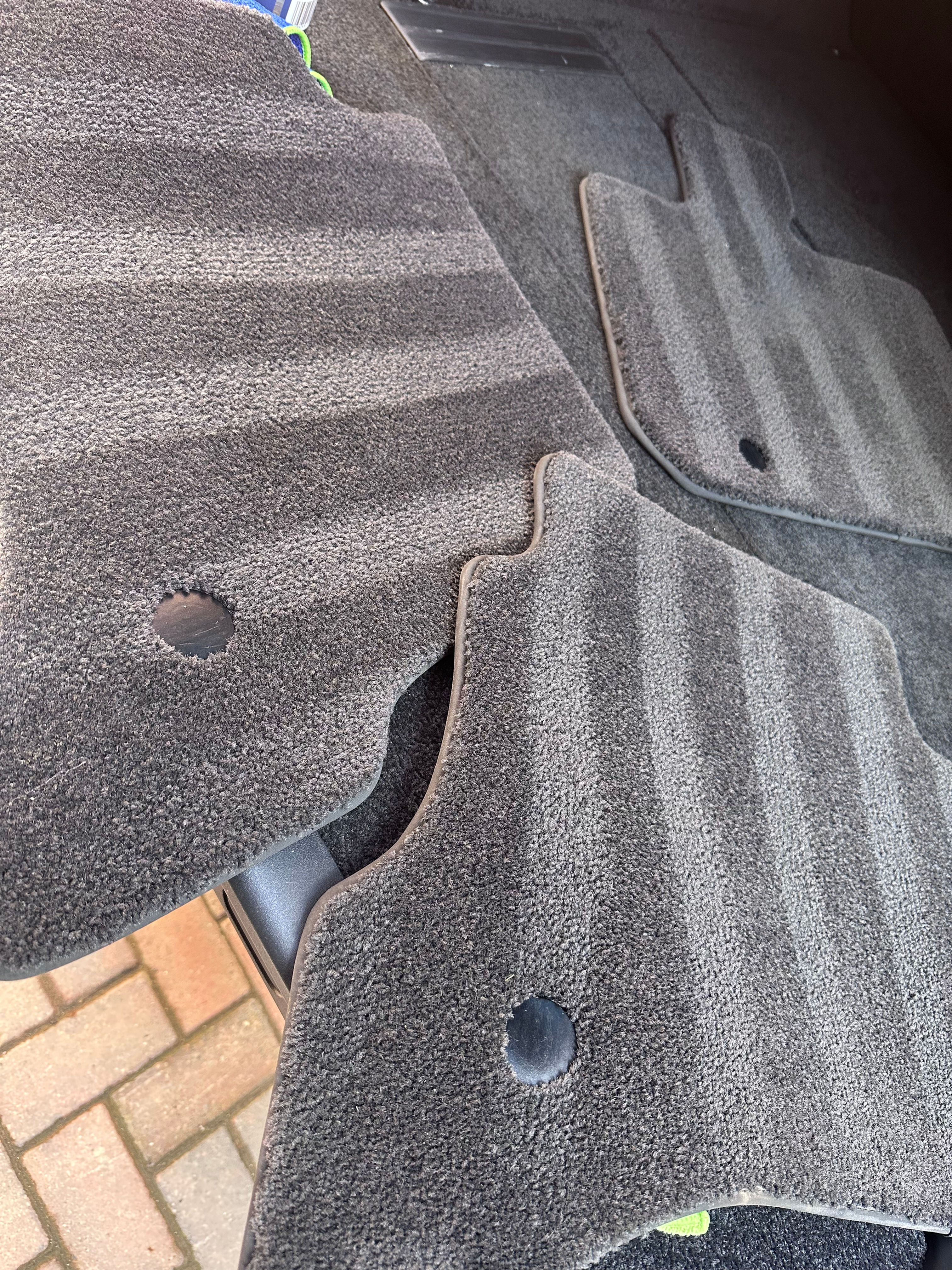 Freshly vacuumed car floor mats after a deep clean detox.