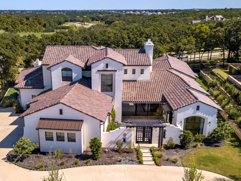 Grand white stucco home with red tile roof