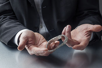 Man looking at a bracelet for a valuation