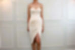A short haired lady wearing a beige tube JACQ cockatil dress with side front slit.
