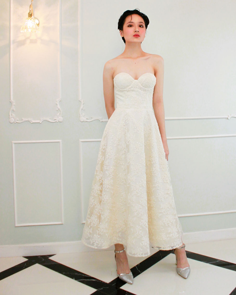 Thumbnail: A short-haired girl wearing a beige French lace JACQ tea length  cocktail dress.