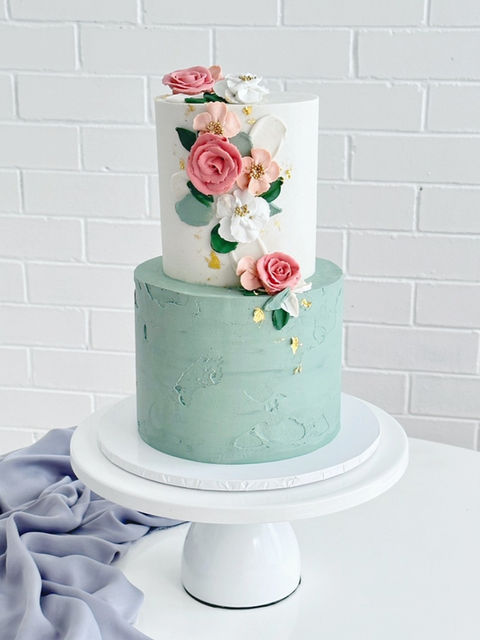 Two tier buttercream wedding cake featuring the most delicate hand piped buttercream florals, gold leaf and slightly textured sage green tones, delivered to Smoked Garage, Fortitude Valley Brisbane.