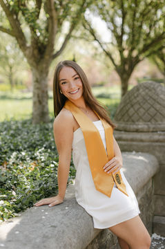 A purdue graduate posing for a picture on campus