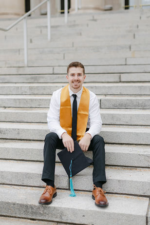 purdue graduate sitting on stairs on campus