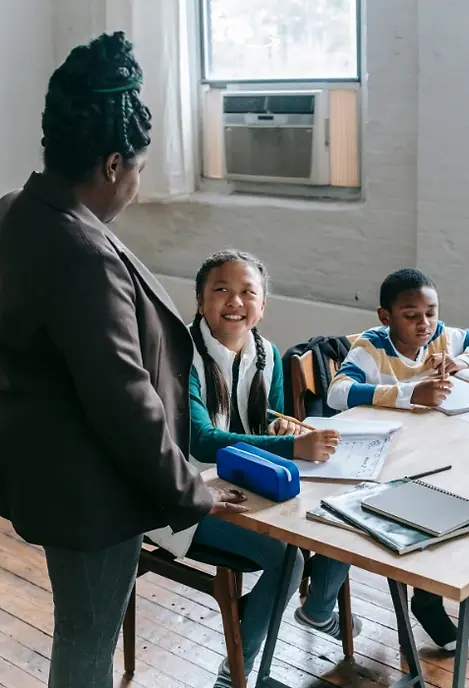 Teacher and kids smiling.webp