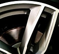 Alloy wheel before and after repair with scratches and scuffs restored onsite