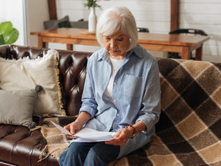 Woman reading documents on a couch