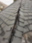 Saddle ridge on slate roof falling apart due to poor installation