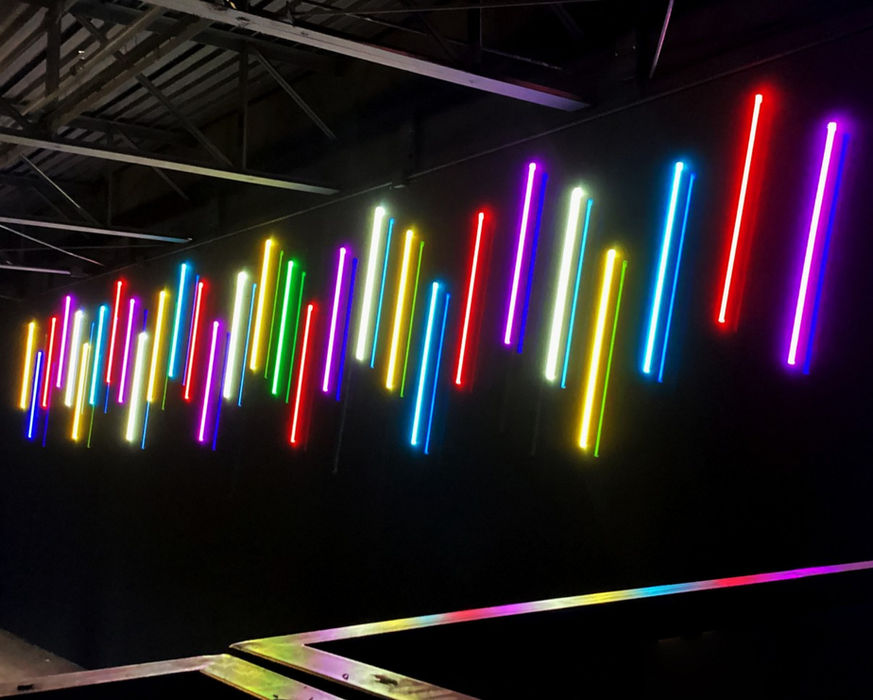 Custom LED faux neon wall signs of with multi-color vertical bars installed inside an arcade by Mello Signs of Fort Worth, TX.