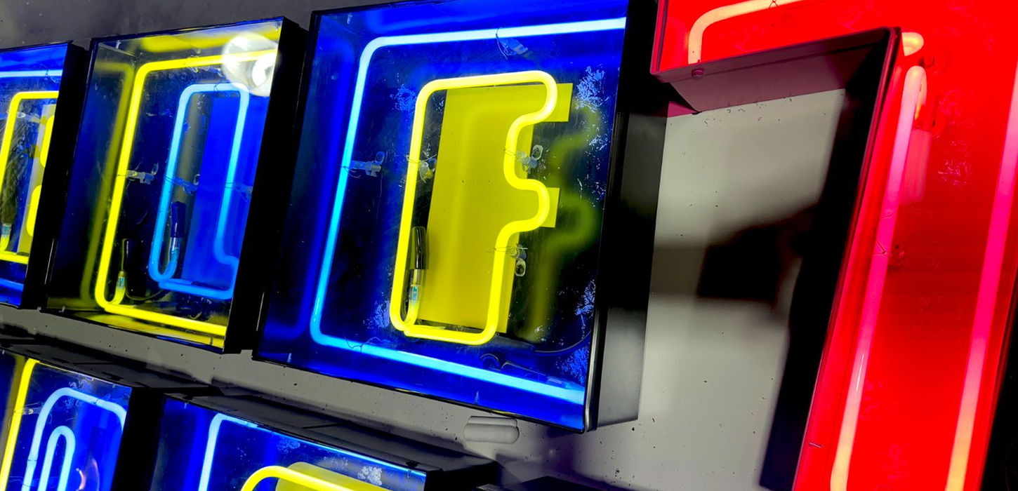 Closeup view of a multi-color-faux neon wall sign at the Mello Signs manufacturing facility before install by Mello Signs.