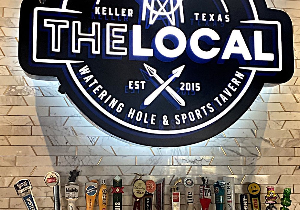 Custom routed push-thru cabinet wall sign installed on an interior wall above beer taps by Mello Signs in Fort Worth Texas.