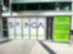 Graphic vinyl exterior wall wrap for a business with white, black and green vinyl printed with company information & sayings.