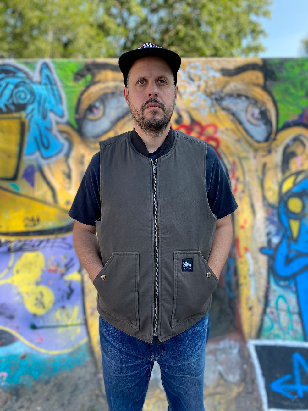 Thumbnail: Front view Slowgold Grand Tourer Stash vest in Moss with custom snap studs and reinforced pockets