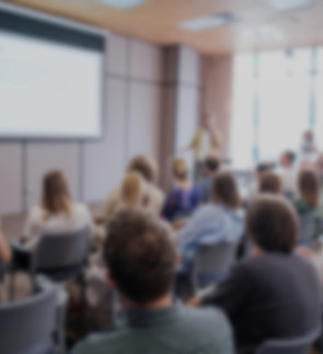 Attendees sit attentively as speaker pre
