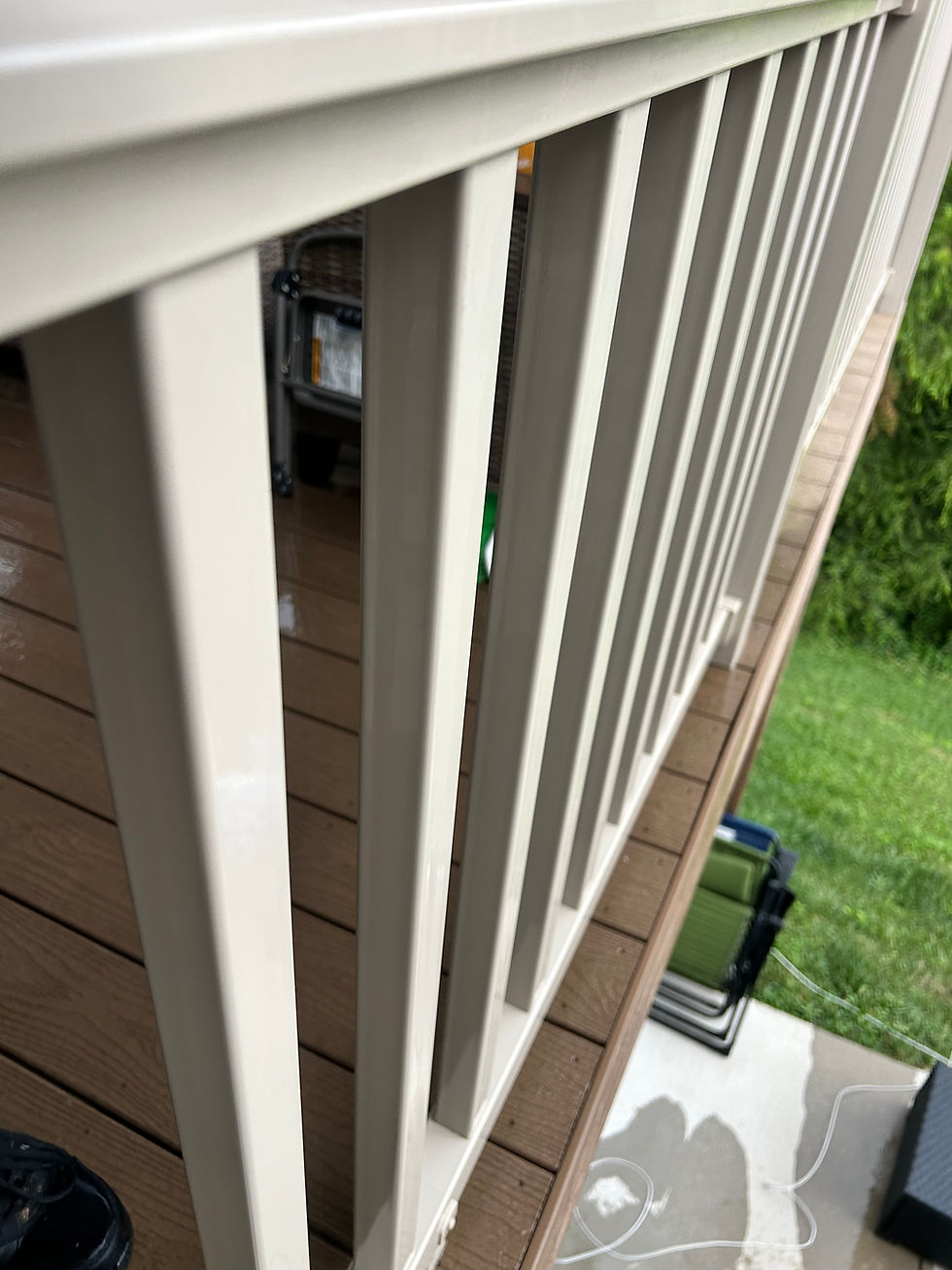 Clean white deck railings and fence cleaning result.