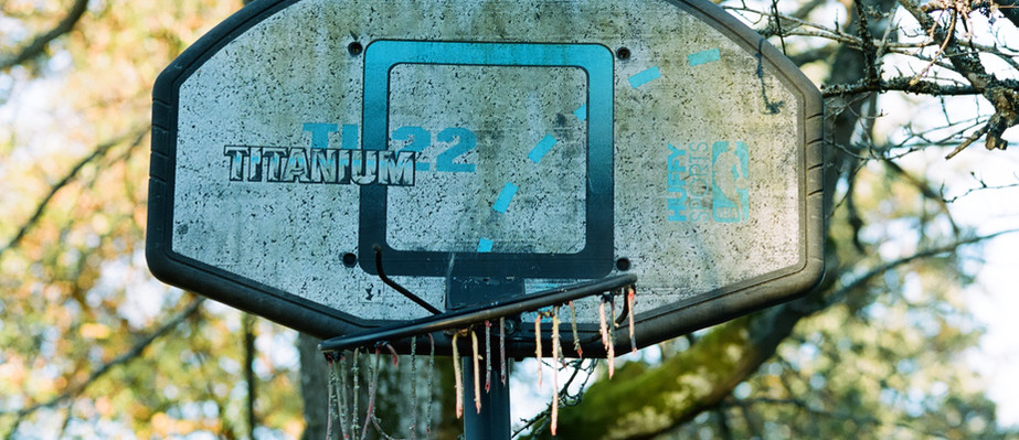 All Weather Basketball Net in suburban settings. often unused and decaying.