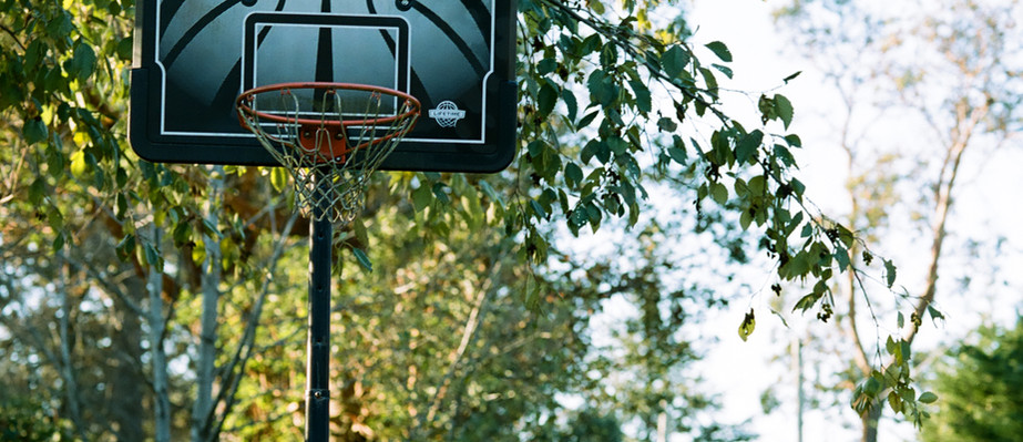 All Weather Basketball Net in suburban settings. often unused and decaying.