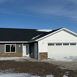 NEW CONSTRUCTION Slab-on-grade 3 bedroom, 2 bath w/2 stall attached garage. Vaulted ceiling with open floor plan, stainless steel appliance package, Quartz countertops in kitchen with High-Definition laminate in bathrooms. Large master bedroom. Double vanity in master bath; luxury vinyl plank in entry, kitchen, bathrooms, living room, dining. Carpet in bedrooms. Kitchen pantry; finished and heated garage with floor drain and so much more. Conditions: Minimum purchase price of $335K; Must be used for primary residency; special assessment on the properties will be provided; offers due March 31, 2026 and must close before August 1, 2026. Contact our office for additional details, floor plan and rendering of the finished product. 