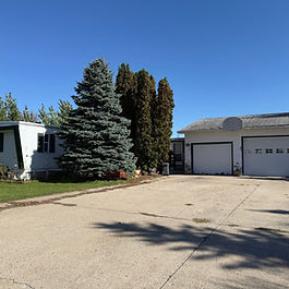 Situated on two lots this manufactured home with addition is looking for a new owner! 3 Bedrooms, 1 3/4 Baths, one is a master en-suite, kitchen w/eat-in area, family room addition, breezeway, insulated and heated garage, newer central air, two sheds included. All this on it's own 2 lots partially fenced in. SOLD "AS IS" 