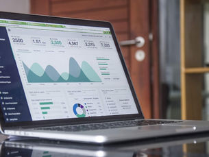 A laptop with financial dashboard on the screen