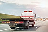 empty-flatbed-tow-carrier-truck-empty-car-carrier-flatbed-tow-truck-vehicle-travelling-nat