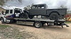 Grey Jeep Gladiator on white flat bed turck in New Braunfels.