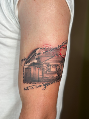 a custom cabin design with a black and grey realism style, including a red line around the tattoo. This is the work of Mud True art one of the tattoo shops in Buffalo NY. 