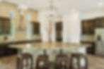 Kitchen counter with brown chairs