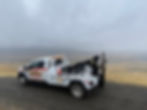 Central Towing tow truck staged on a hillside roadway during a roadside recovery in the Fremont area on a foggy day.