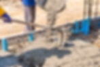 worker-using-hoe-spread-concrete-floor-construction-site.jpg