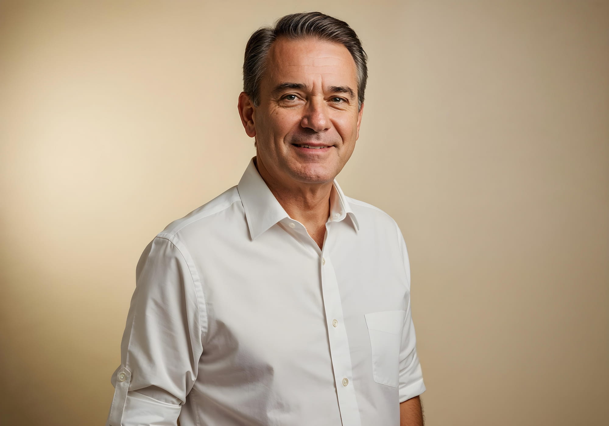 Portrait of a man smiling in a white shirt