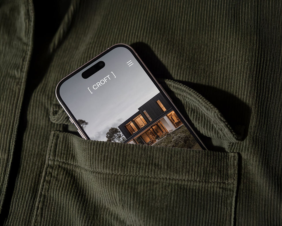 CROFT boutique builder website shown on a mobile phone, displaying a modern architectural home at dusk