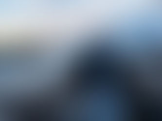 Man standing smiling for a photo on the Brooklyn Bridge