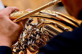 Adult student playing French horn.