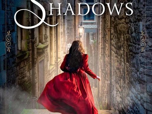 a woman with long wavy brown hair in a bright red long sleeved dress runs down a cobblestone alley lined with brick buildings toward a cross street. 