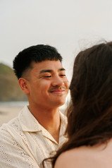 Man smiling at his fiance at Cannon Beach for engagement photography