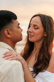 Couple looking at each other in the sunset at Cannon Beach for engagement photography