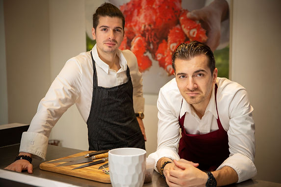 Manos brothers of Gourmaze standing in kitchen